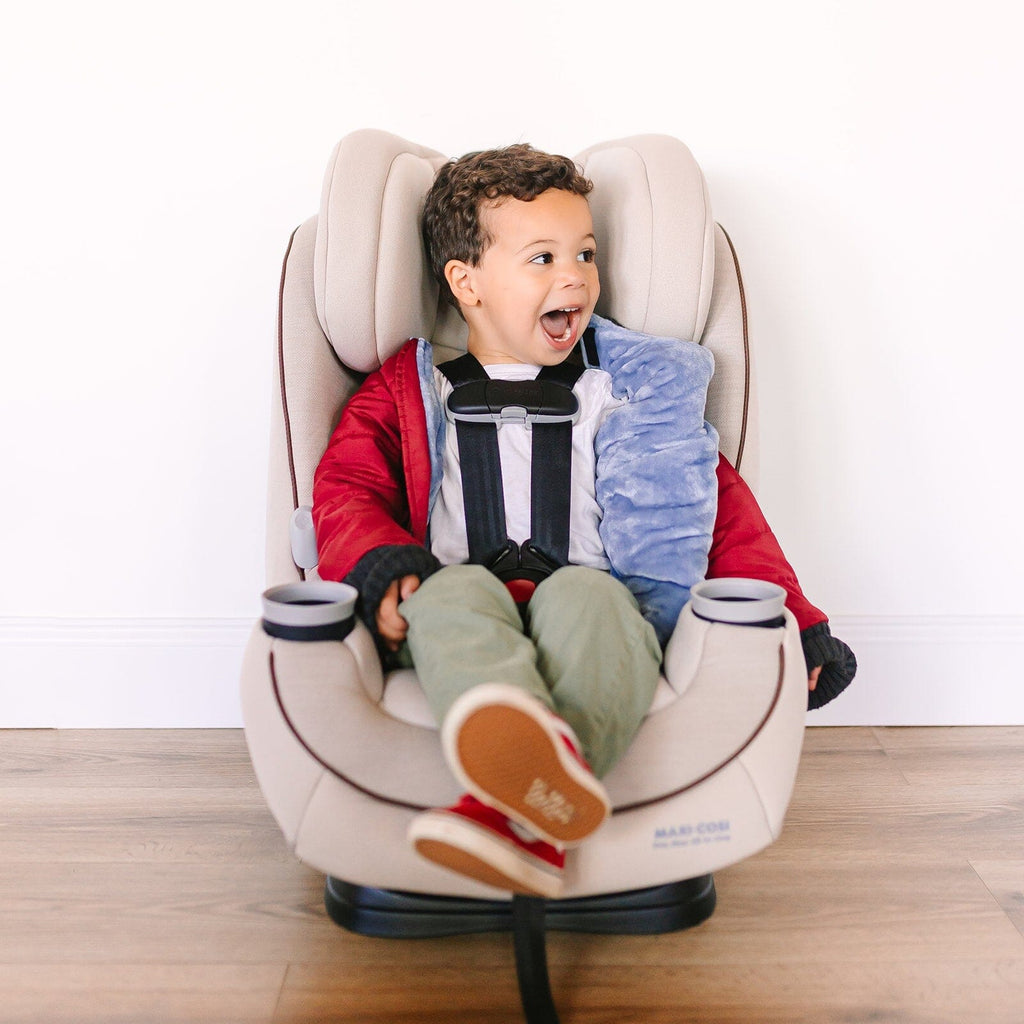 red car seat coat with little boy looking surprised in his car seat jacket