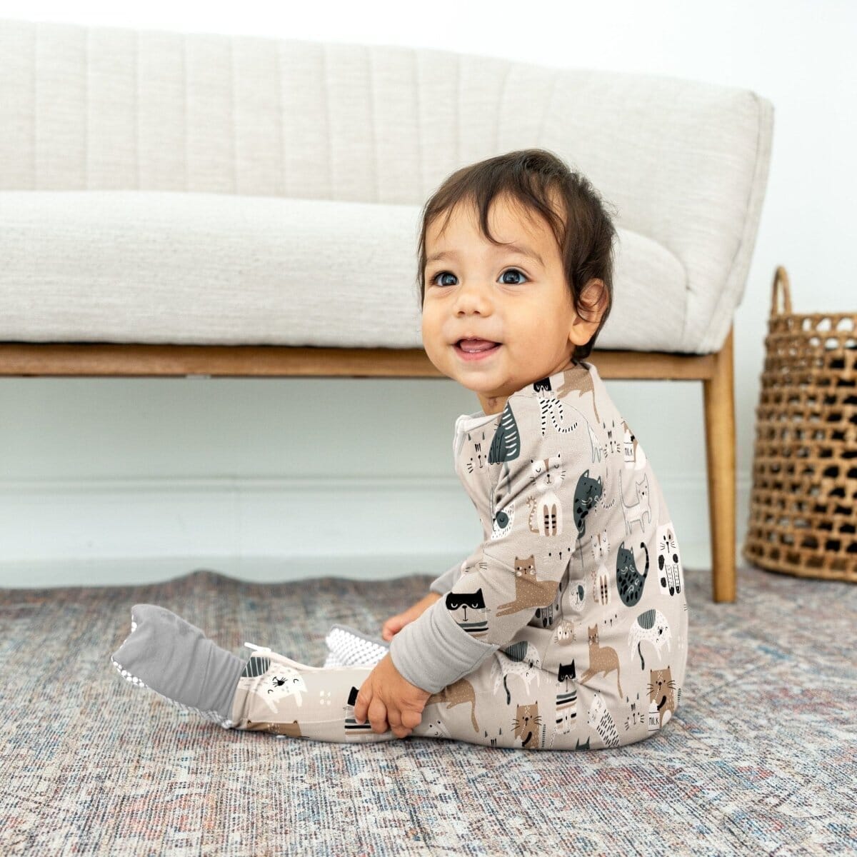 little boy with dark hair wearing taupe and tan bamboo blowout blockerz pajamas
