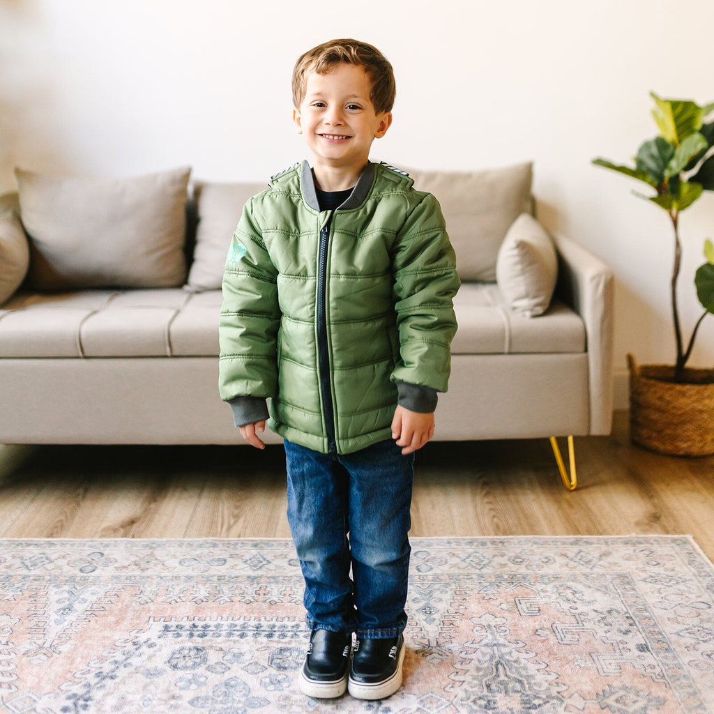 Puff/Green 
Little boy with brown hair wearing a green car seat coat.  The coat is zipped up and the little boy is smiling.